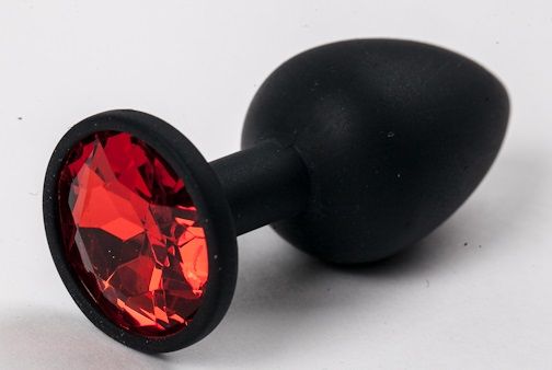 Черная силиконовая анальная пробка с красным стразом - 7,1 см.